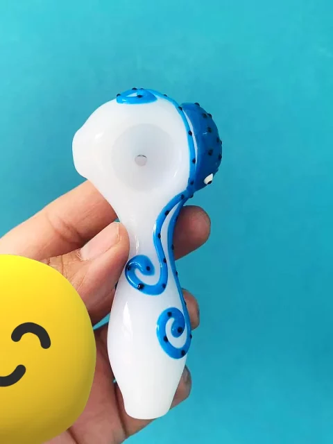 Explore the depths of artistry with our Luminous Hand-Painted Octopus Glass Pipe. Measuring a compact 10cm (approximately 3.9 inches), this unique piece is crafted from premium borosilicate glass, renowned for its exceptional durability and resistance. Each pipe features a captivating, hand-painted octopus design that brings a touch of oceanic wonder to your collection. The intricate details of the octopus, from its intelligent eyes to its gracefully swirling tentacles, are meticulously rendered, making every pipe a miniature work of art. The base color of the pipe provides a beautiful backdrop for the vibrant blue of the octopus, creating a striking contrast that catches the eye. Designed with both aesthetics and comfort in mind, the pipe's ergonomic shape fits perfectly in your hand, offering a secure grip. Its thoughtful construction ensures a smooth and enjoyable experience, making it as practical as it is visually appealing.
