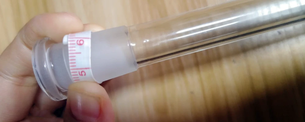 Using a tape measure to wrap around the frosted joint end of a downstem to calculate diameter from circumference